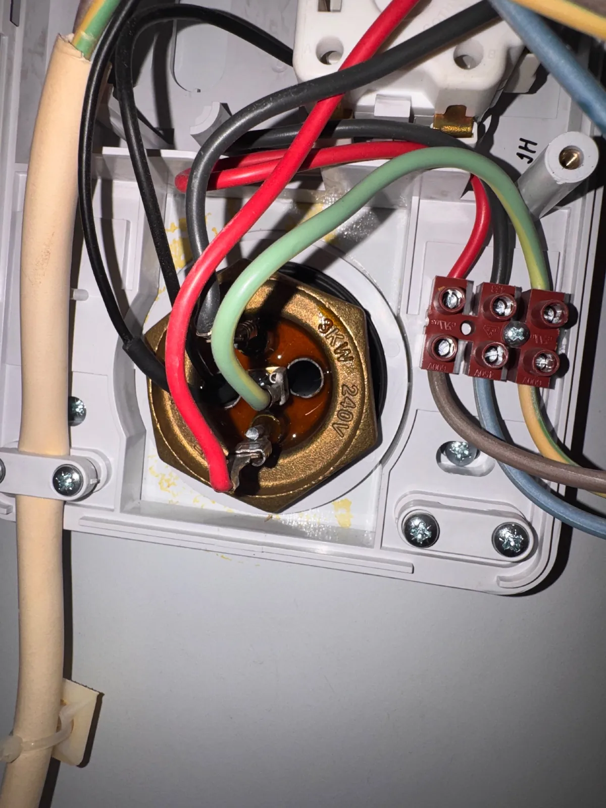 Close-up of a 3 kW immersion heater element with its supply wires connected at the terminals